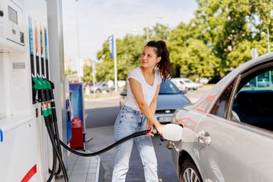 Person filling their car with gas