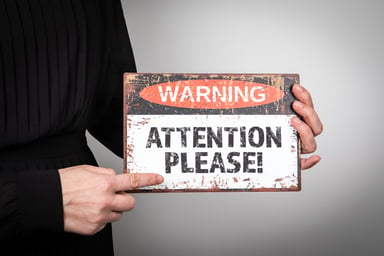 holding warning sign attention please