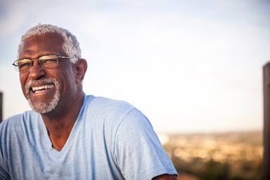 Man 60s smiling outdoors GettyImages-976789418
