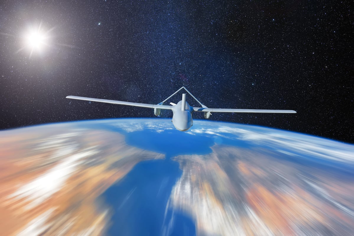 A drone in space flying over the earth.