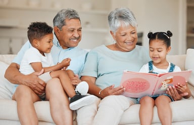 Smiling couple reading books to children