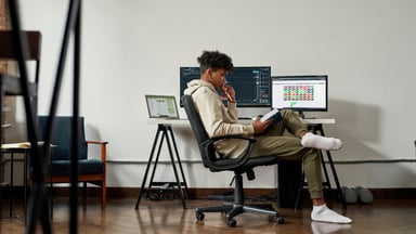 young investor studies financial charts.