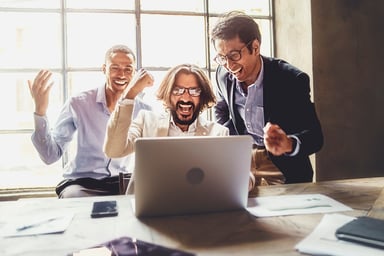 investors look at laptop and celebrate.