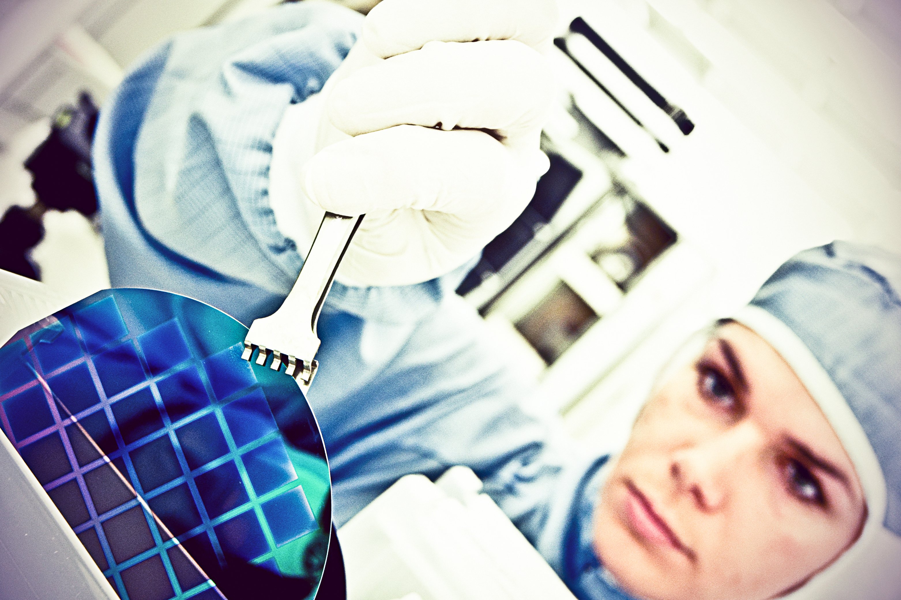 technician holds chip inside a fab