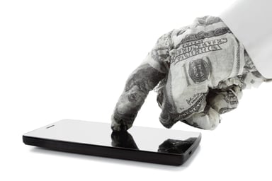 a hand wrapped in bills touches a smartphone