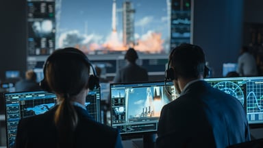 engineers watch rocket launch from command center.