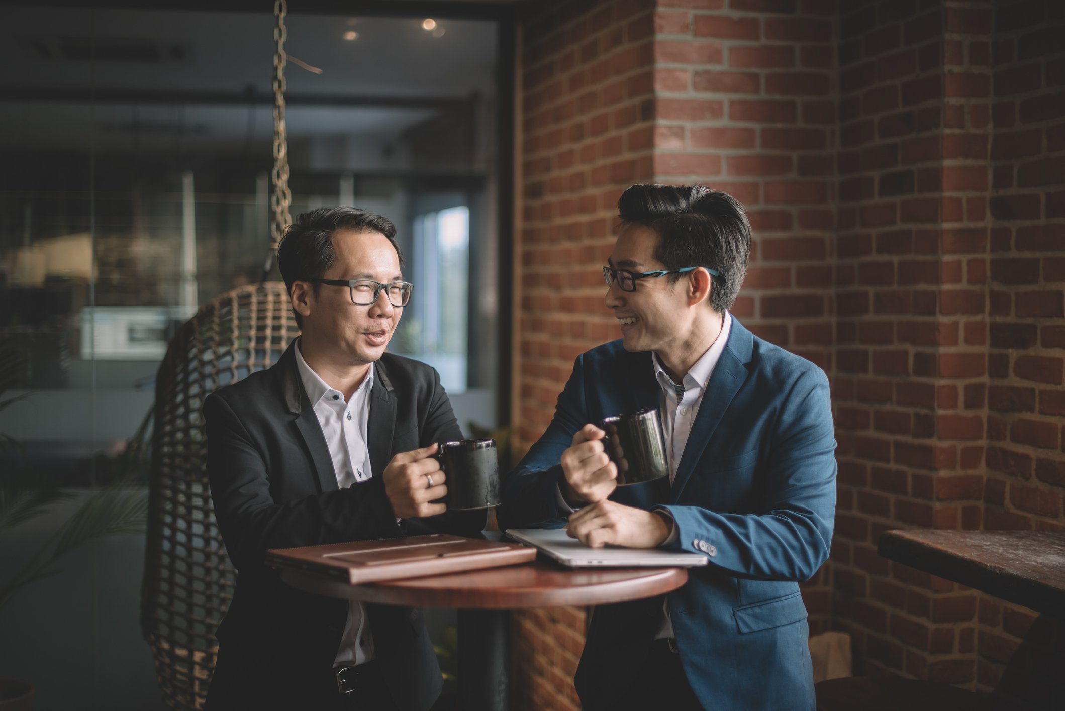 Two business people meeting over coffee.