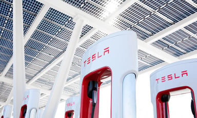 group of tesla super chargers with logo in view