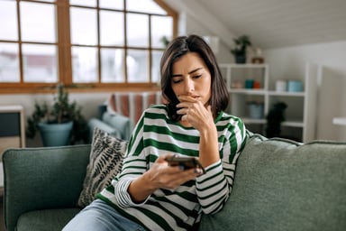 Worried person looking at phone