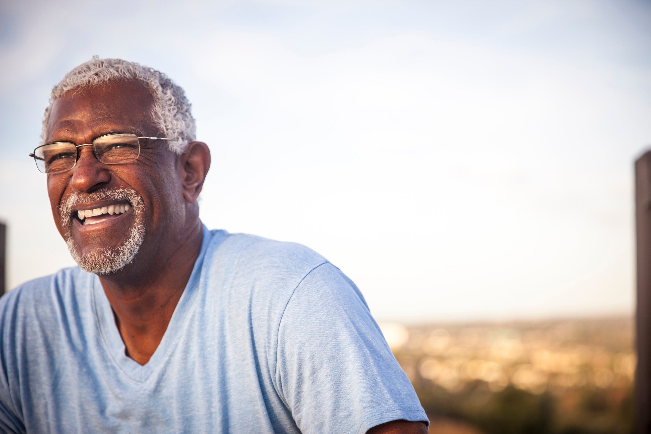 Man 60s smiling outdoors GettyImages-976789418