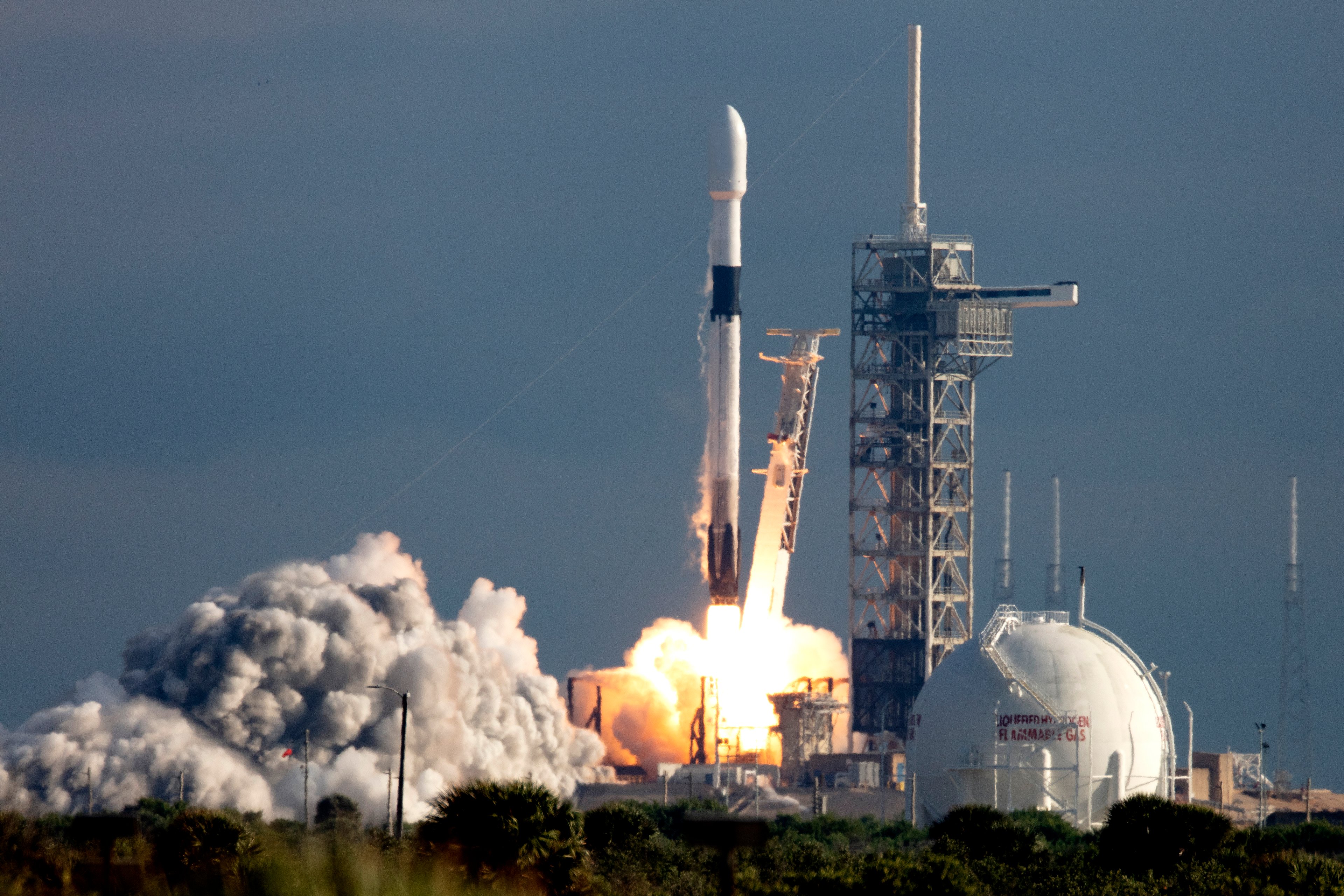 A space rocket starting to blast off from Earth