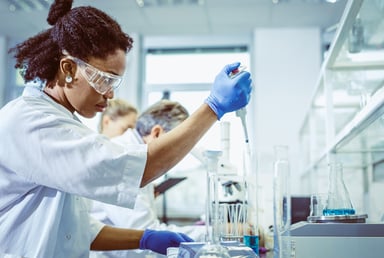 scientist mixing chemicals with a pipette