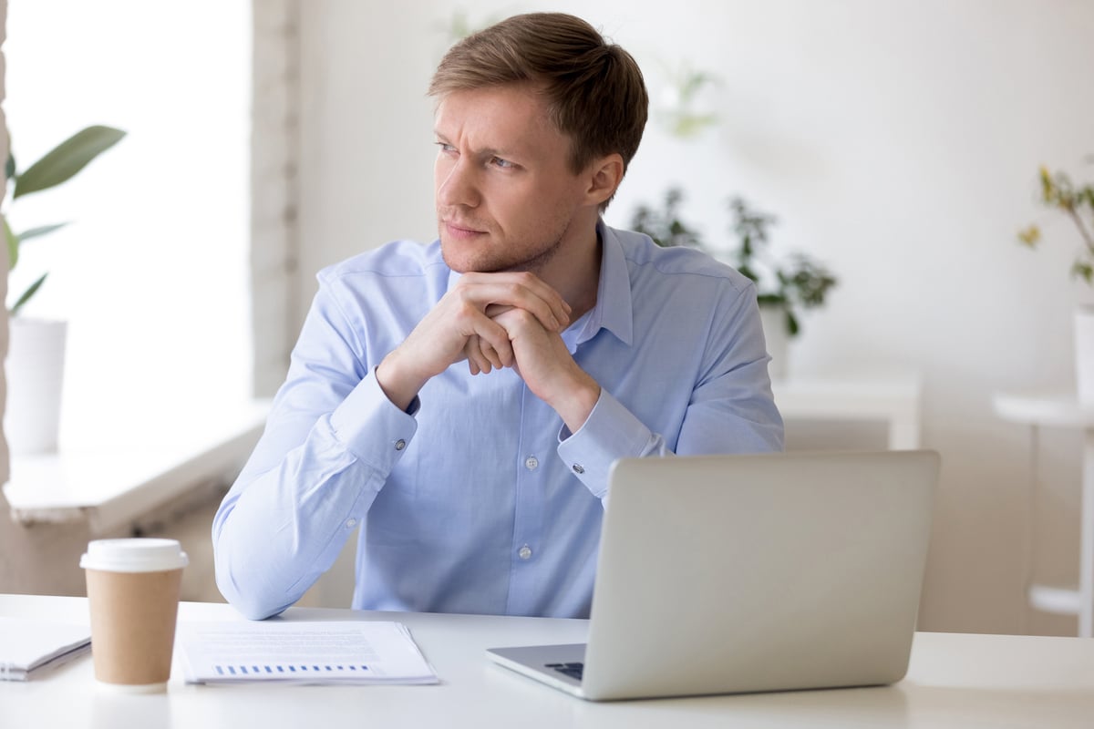 concerned investor looks out window.
