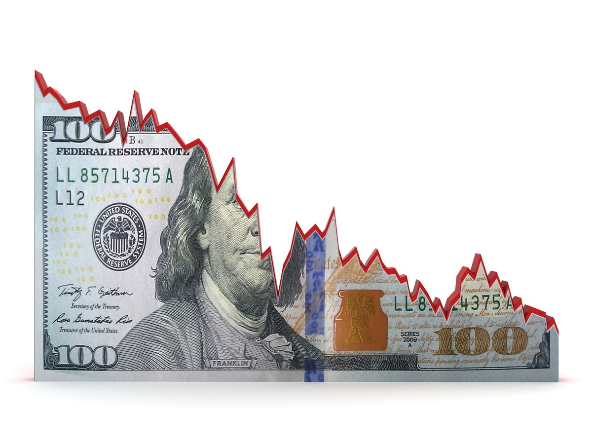 The bottom half of a torn $100 bill, with a red tear line resembling a downward stock chart.