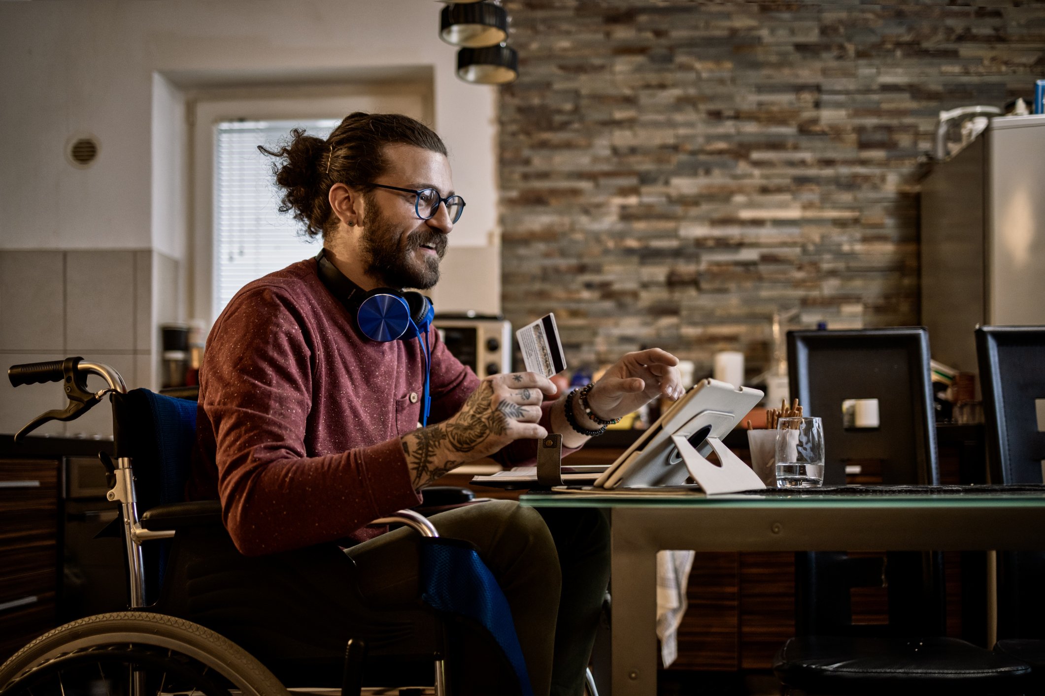 person in wheel chair looking at their tablet