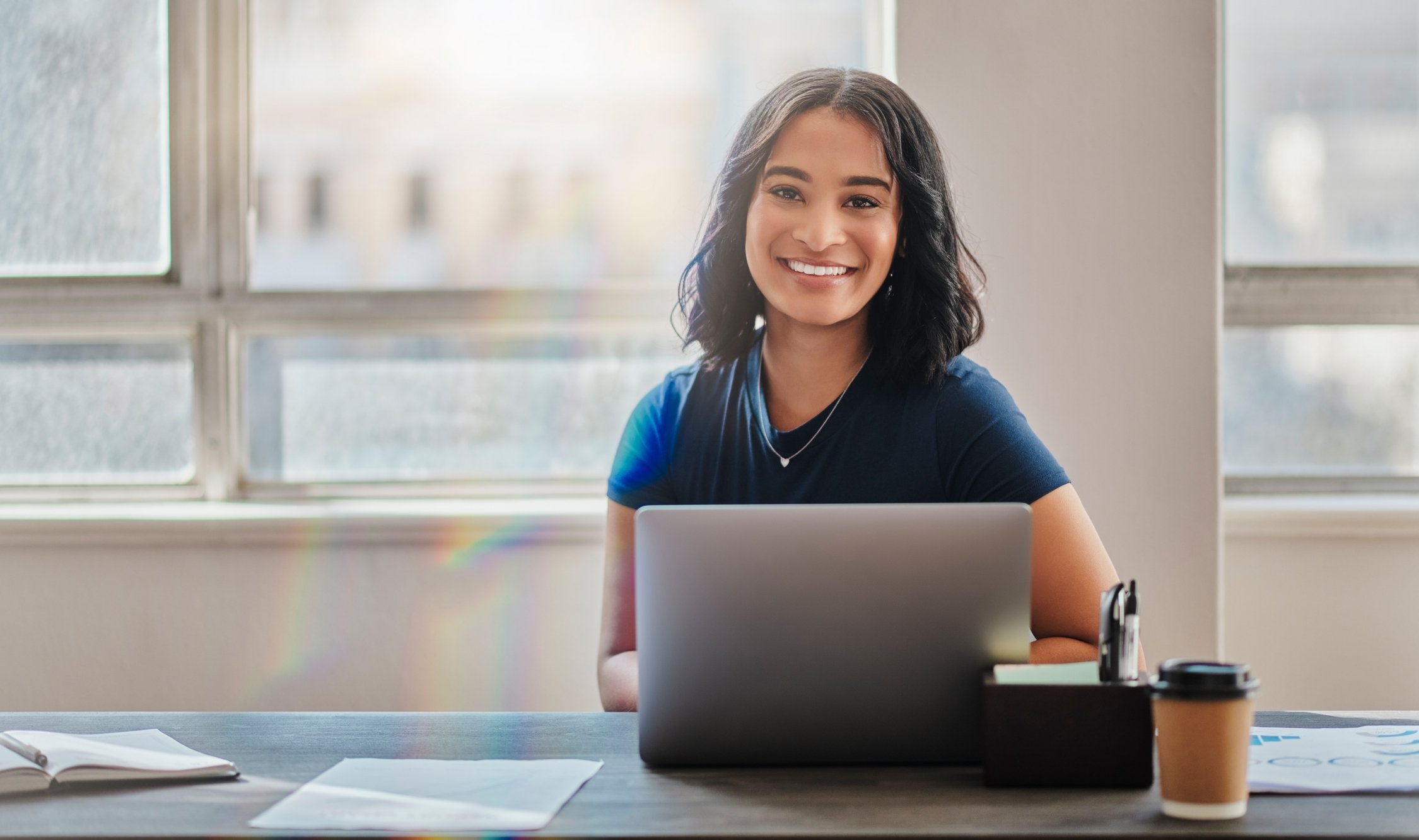 woman 20s smiling laptop GettyImages-1430319207