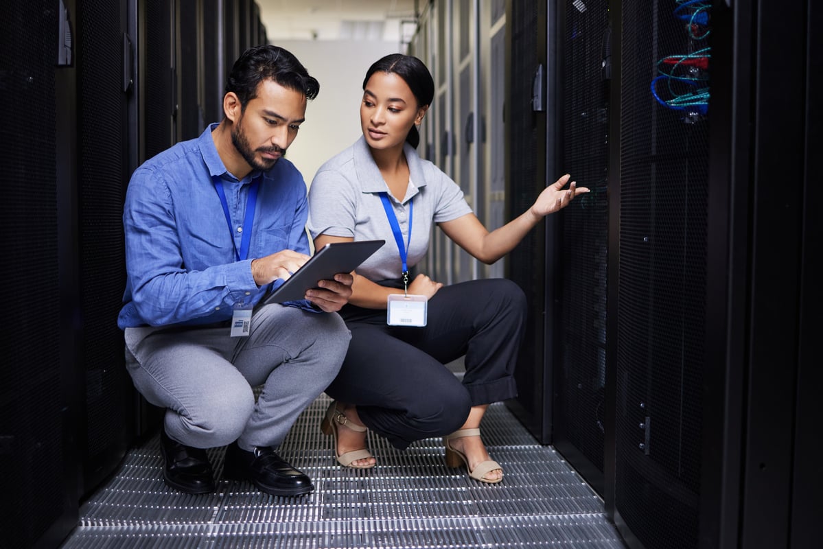 technicians monitor cloud computing equipment.