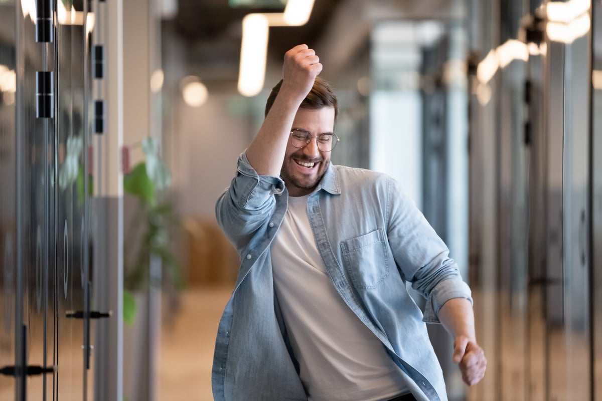 investor raises arm in celebration.