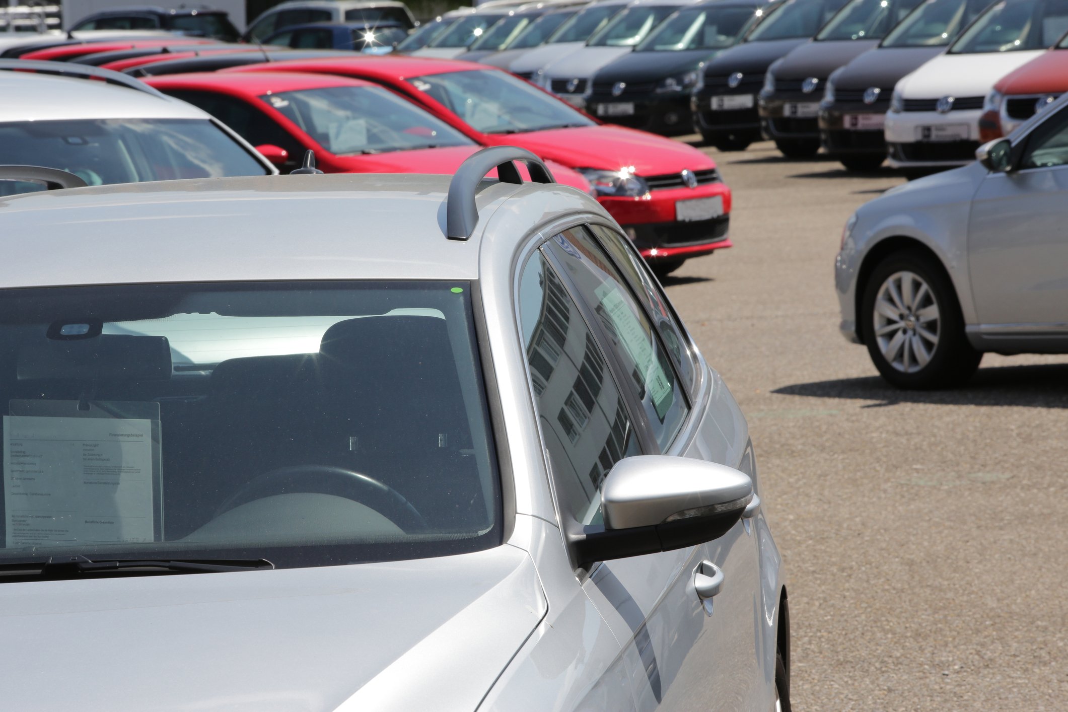 Several cars in a lot, as if for sale
