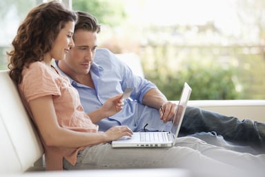 Couple shopping online with credit card and laptop.