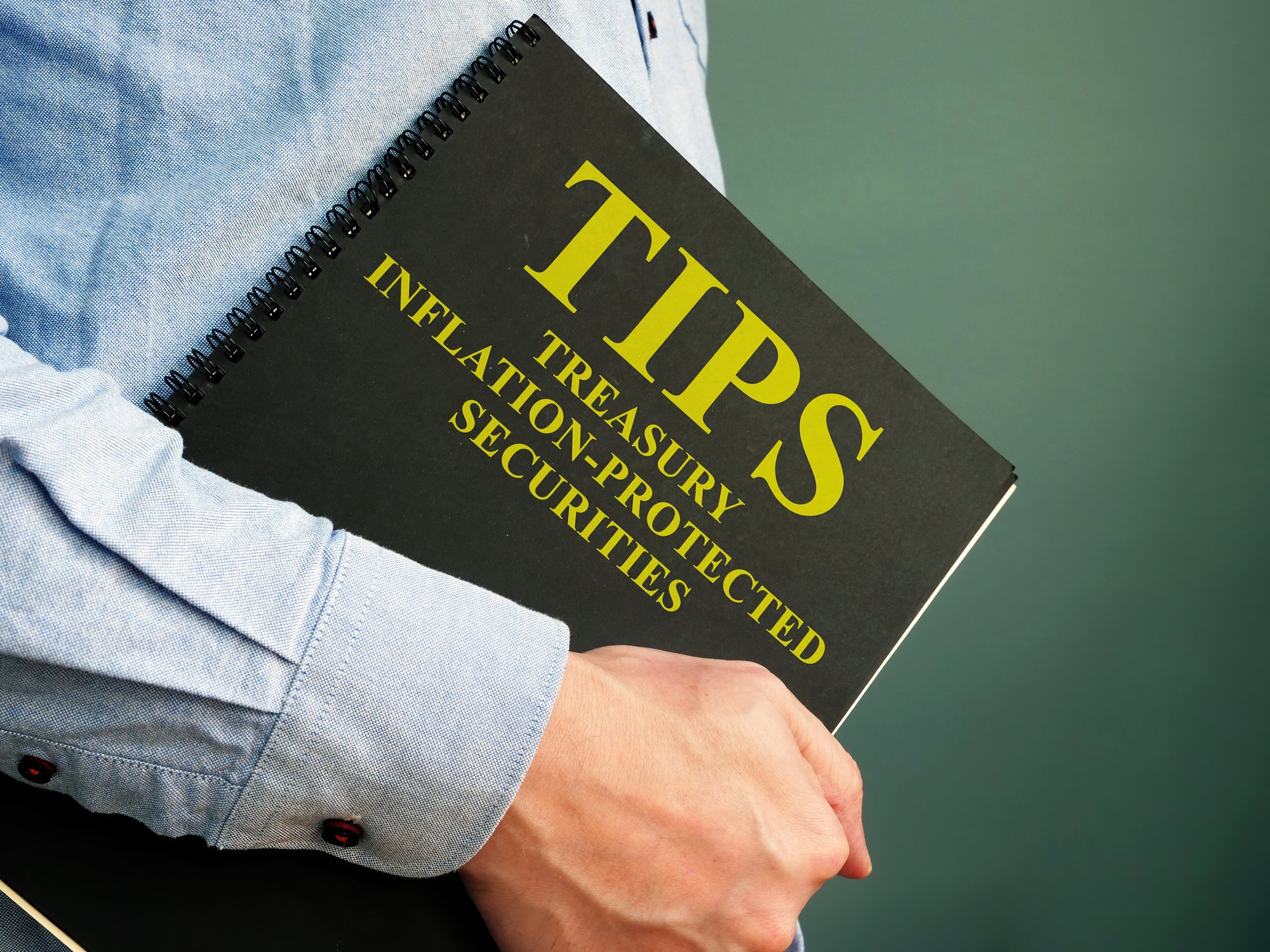 Person holding notebook labeled TIPS