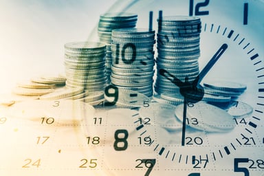 Stacks of coins with the image of a clock and calendar superimposed over them.