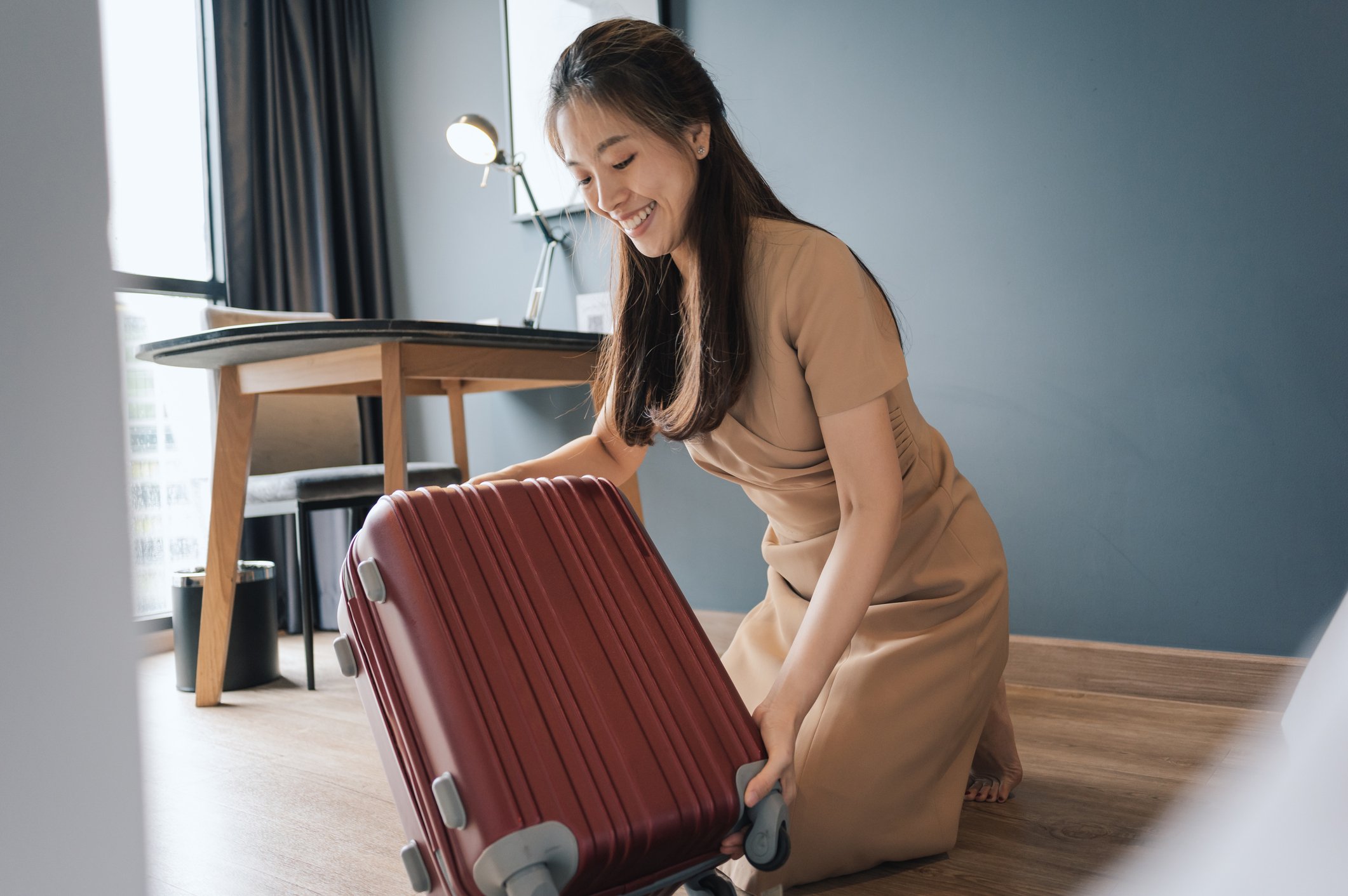 person with suitcase in Airbnb-type room