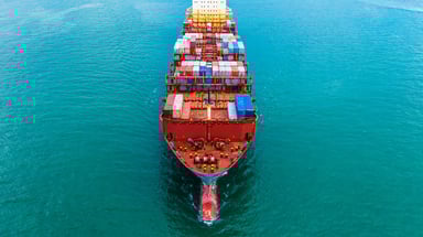 A shipping barge loaded with metal shipping crates.