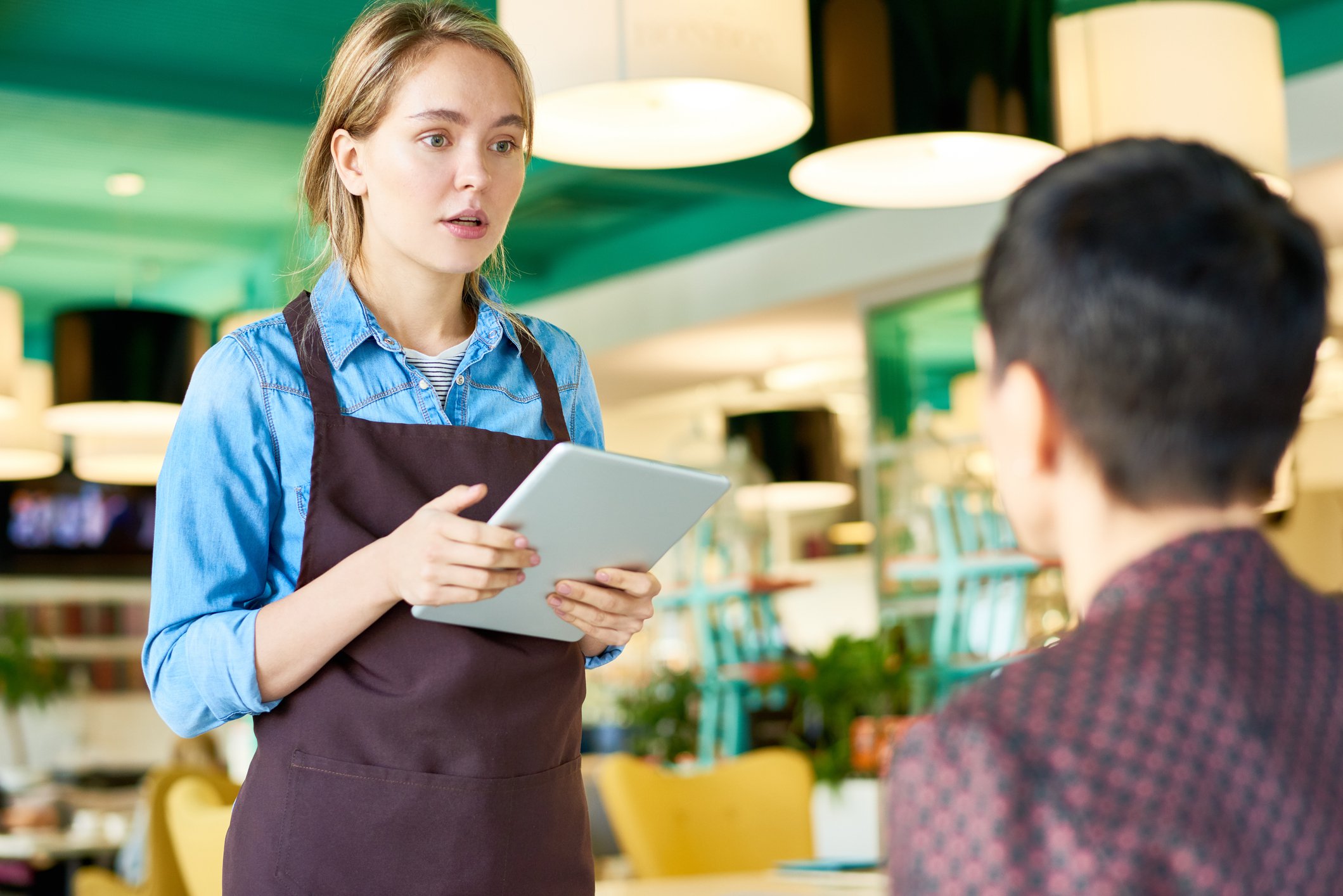 Waitress speaking with her male customer.