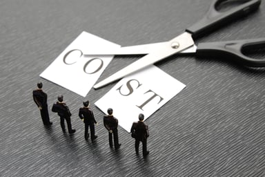 Scissors cutting a postcard that reads Cost in half