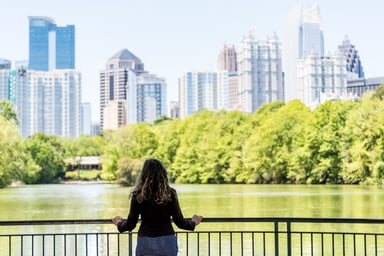 Person looking at Atlanta city skyline in park.jpg
