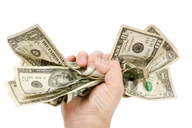 Gripping dollar bills in an iron fist