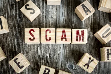 The word SCAM spelled out on wooden blocks.