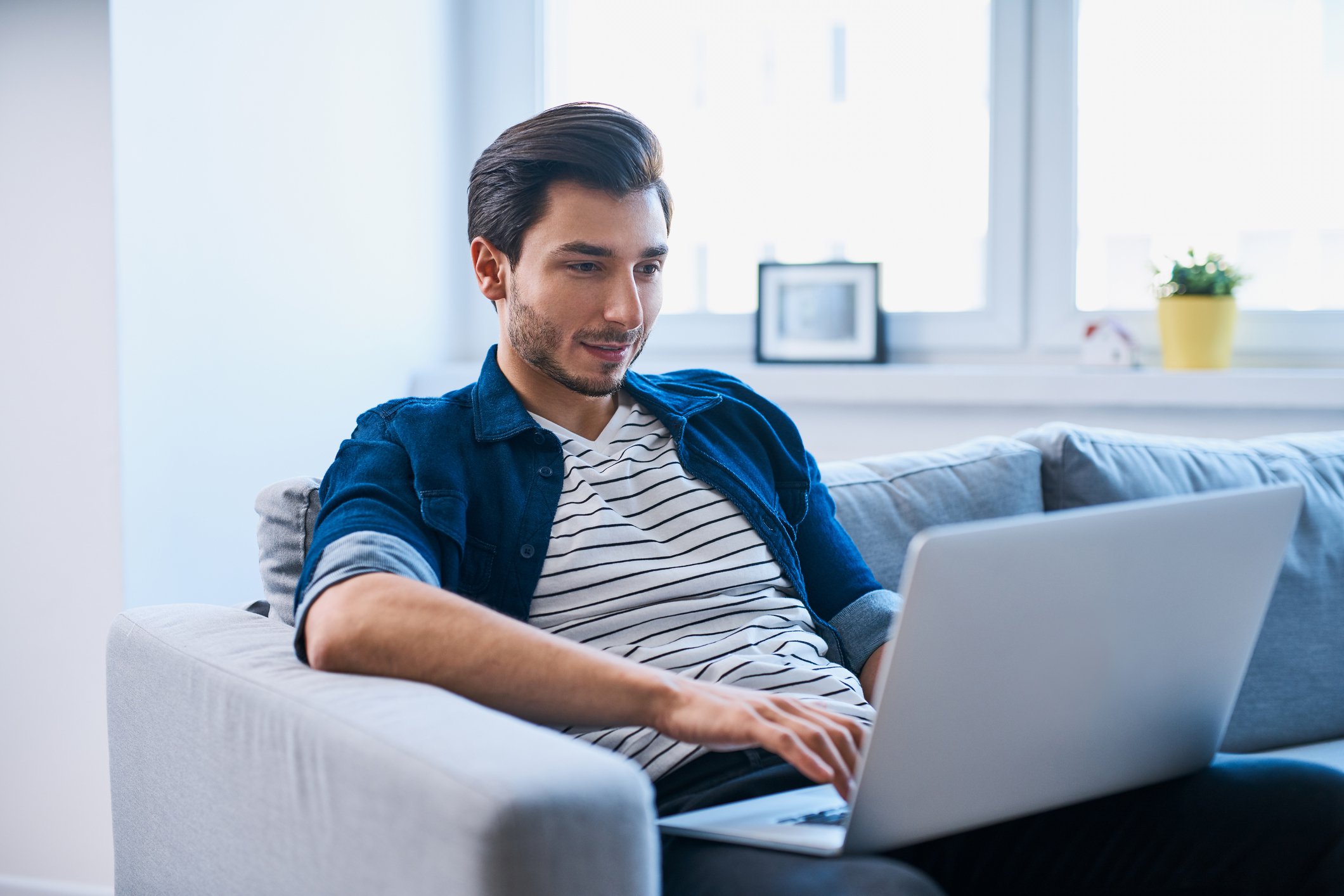 person on couch with laptop