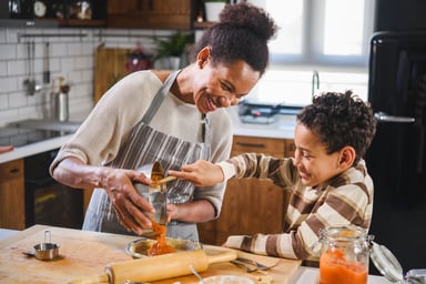 Mother and son baking together.