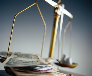 Close-up of scale with money