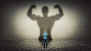 Tiny man with his big strong shadow behind him.jpg