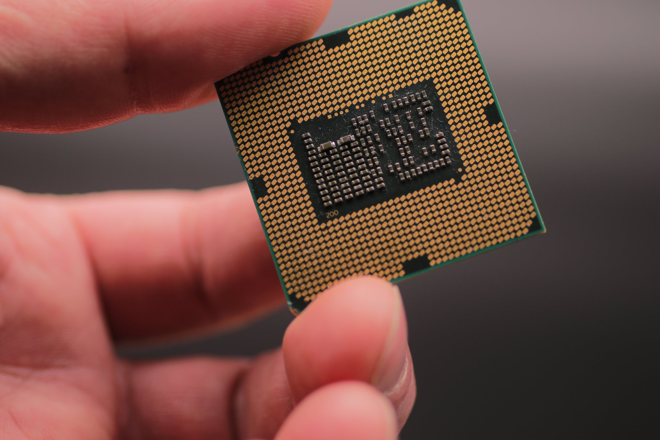 a hand holding a computer chip