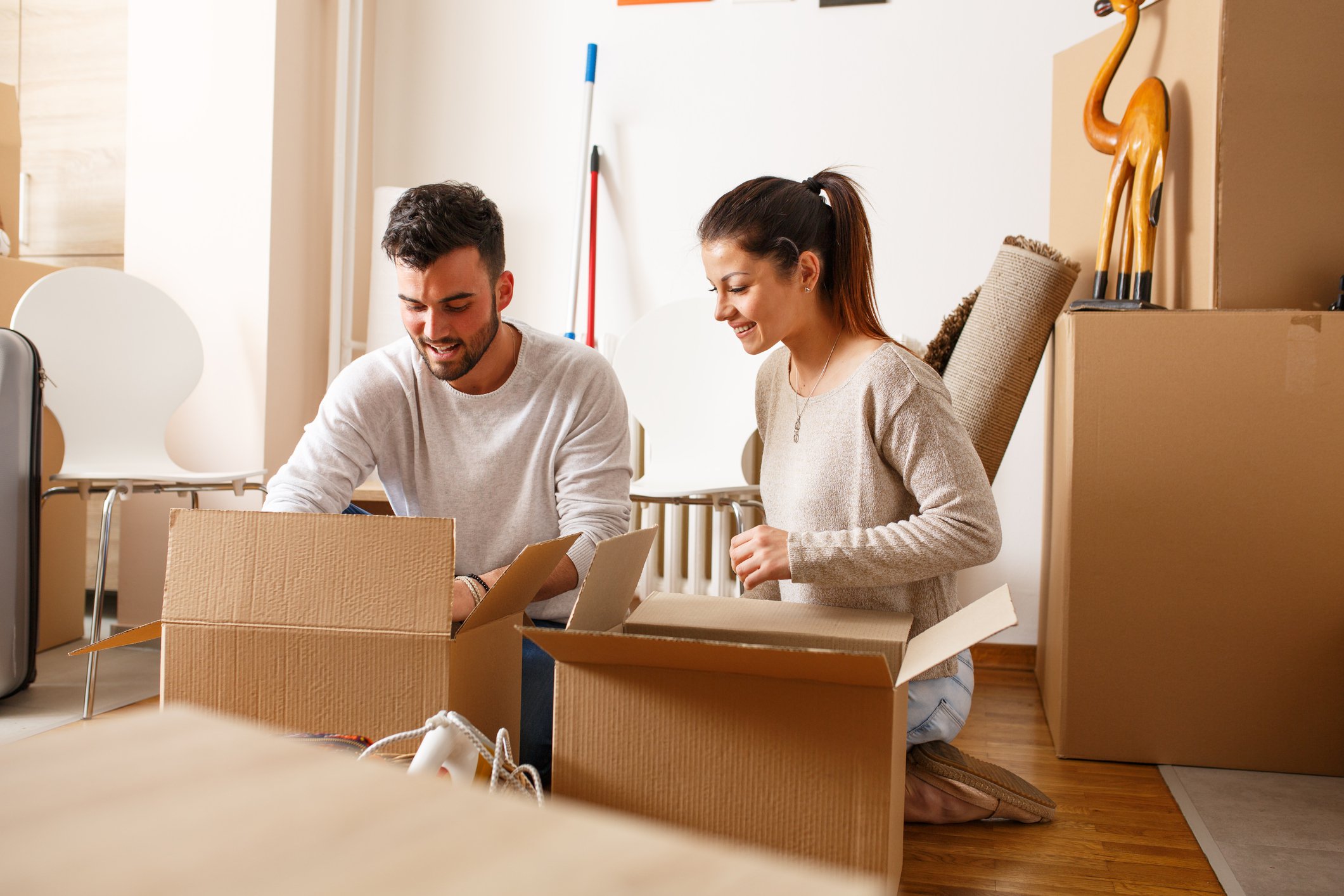 A young couple unpacking moving boxes