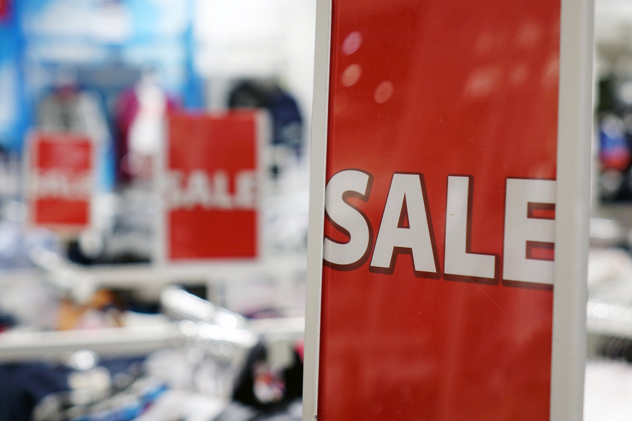 A large red sign reading Sale