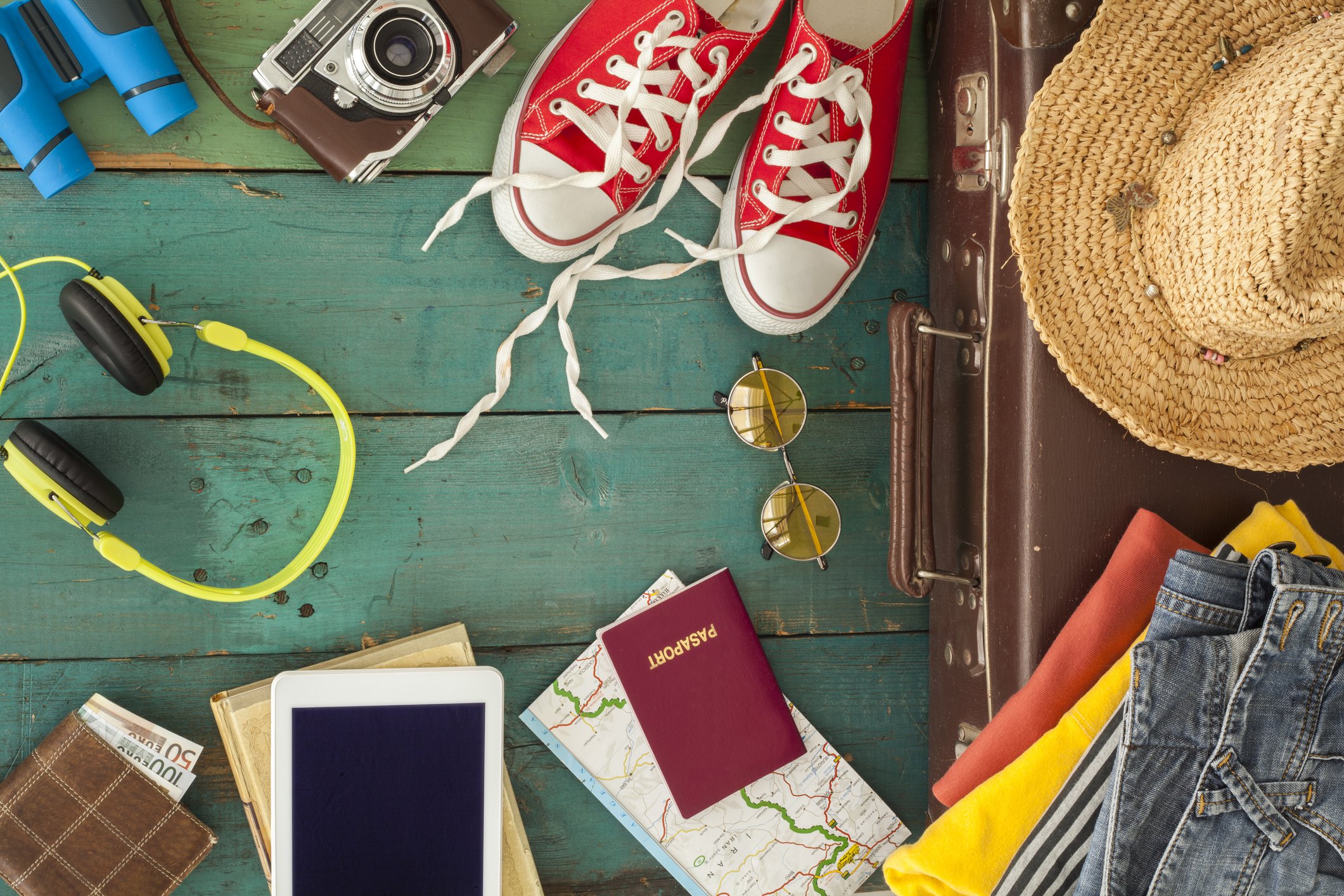 Various travel-related items from a suitcase spilled out.
