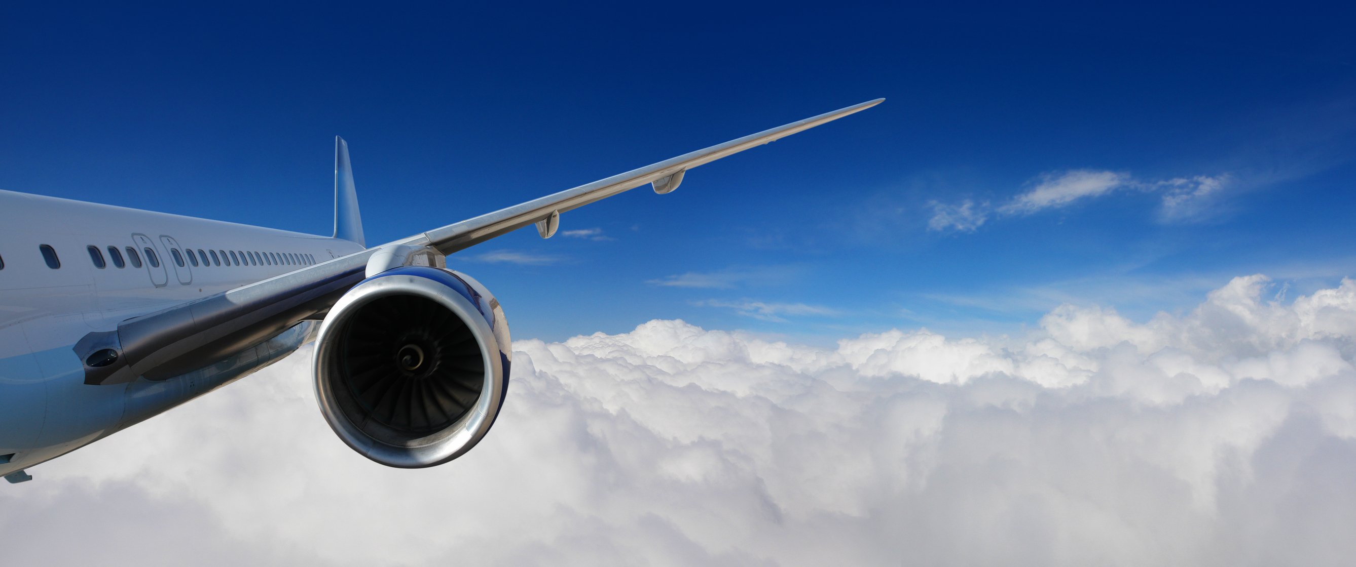 Jet engine on plane in clouds
