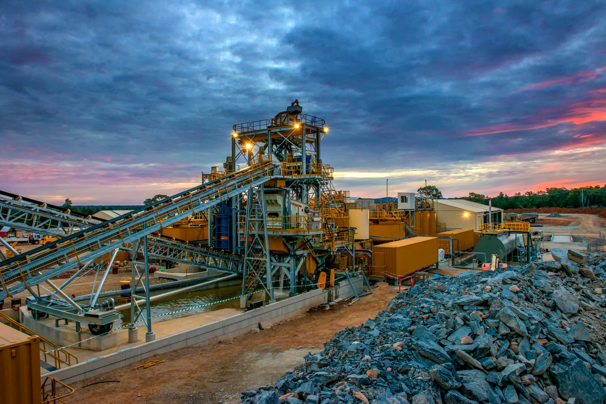 A cobalt mine with the sun setting in the background.