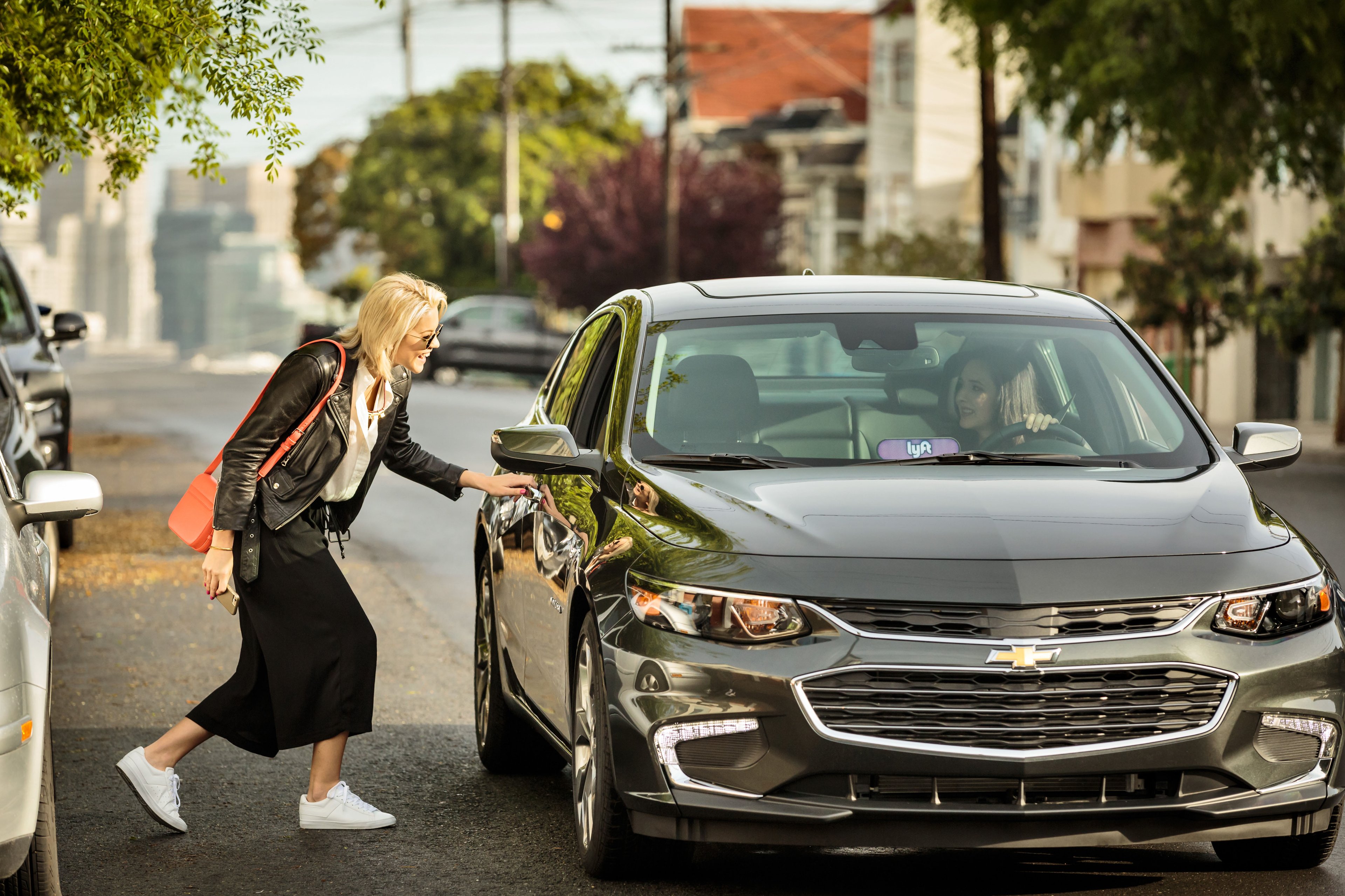 A person entering a Lyft vehicle