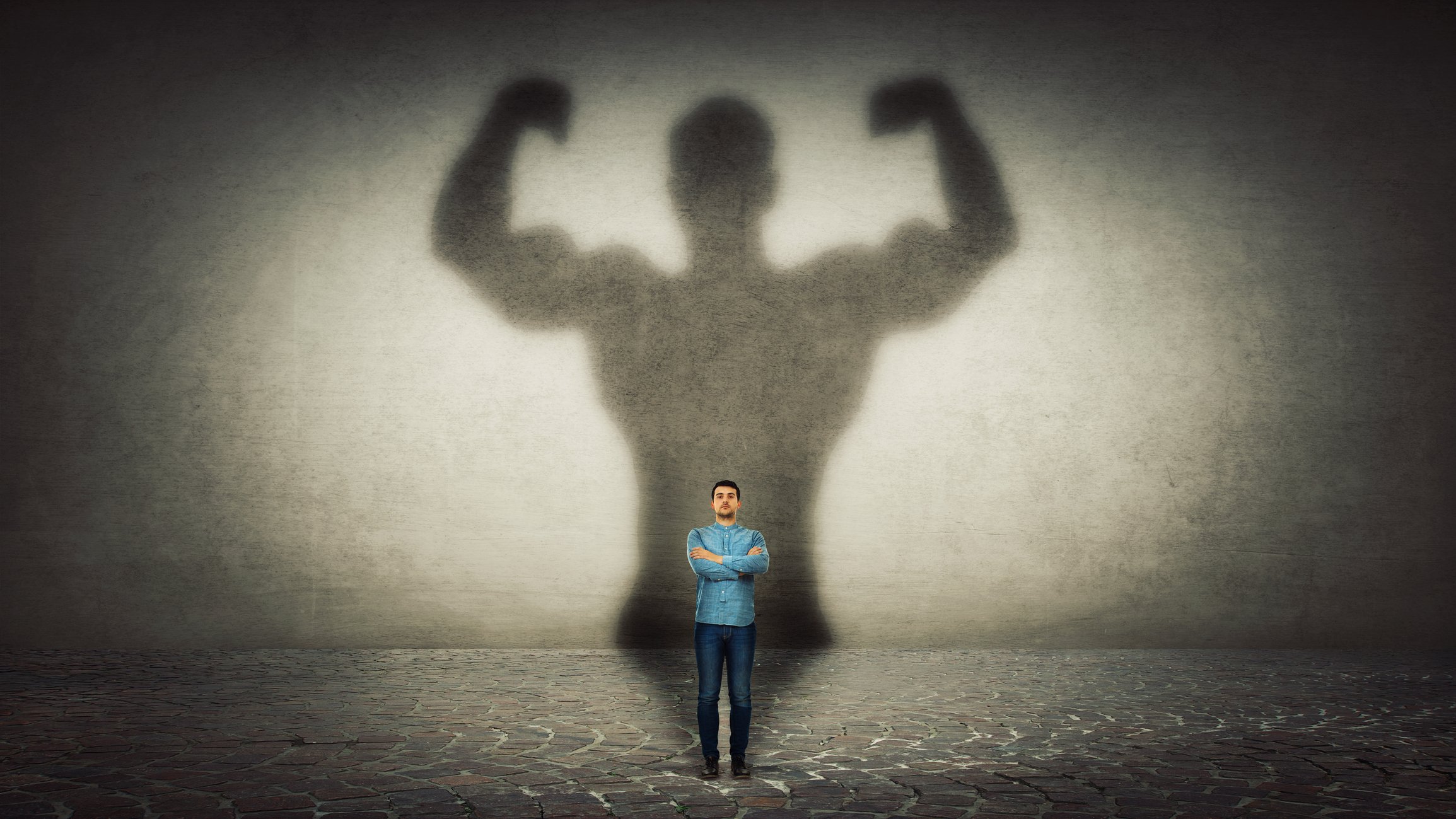 Tiny man with his big strong shadow behind him.jpg