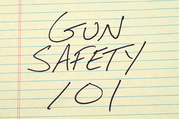 "GUN SAFETY 101" written in black on yellow lined paper