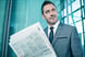 Businessman in Suit Reading Newspaper Getty