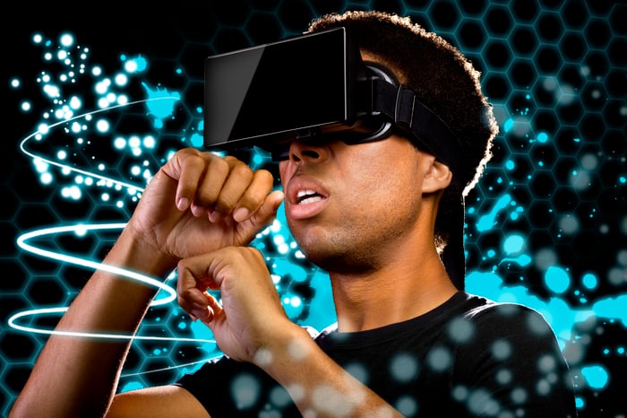 Man wearing virtual reality goggles watching light painting
