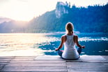 Meditation Girl Sitting on a Dock by a Lake