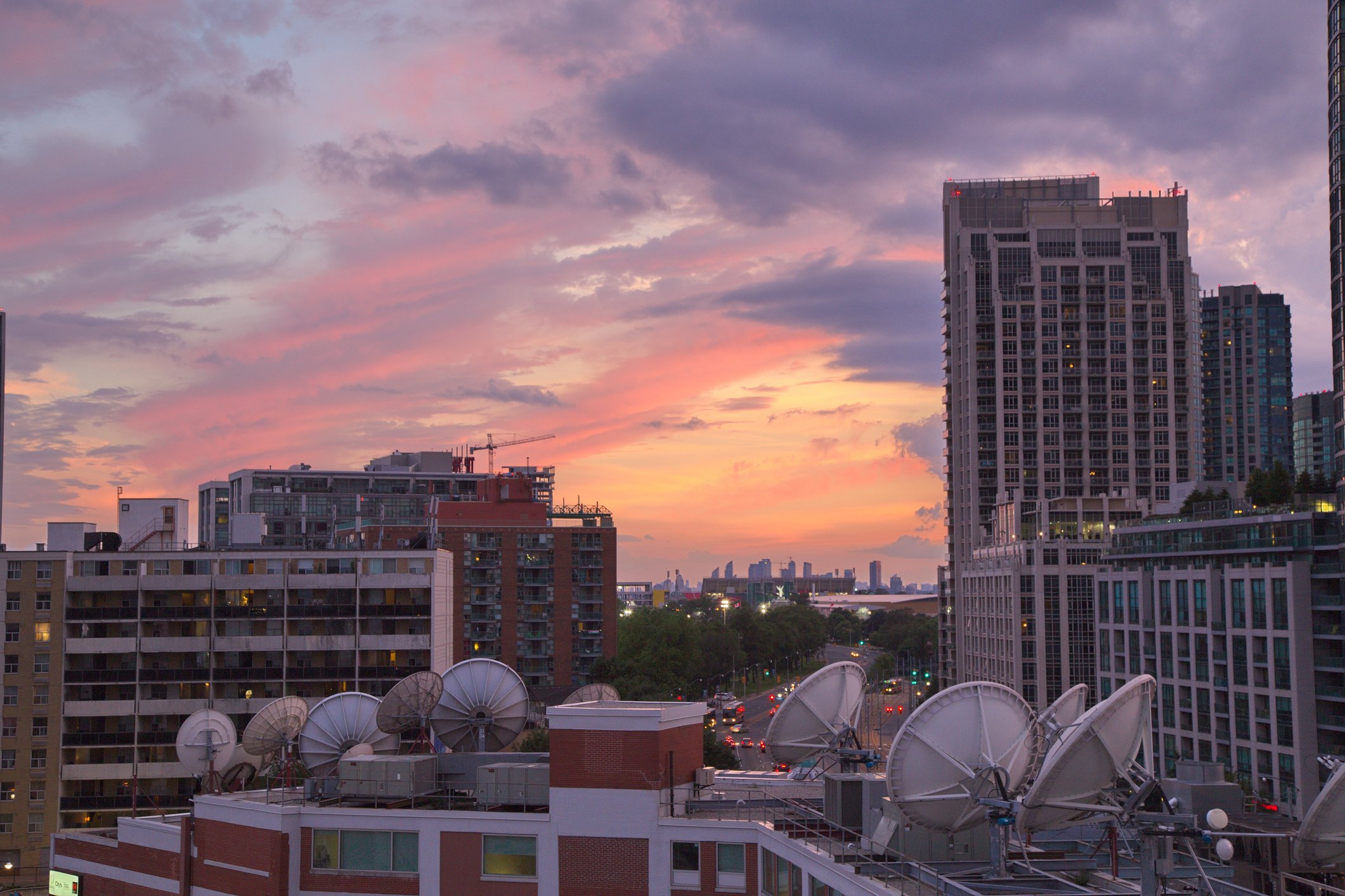 Parabolic satellite dish space technology receivers over the city, Toronto, Canada.